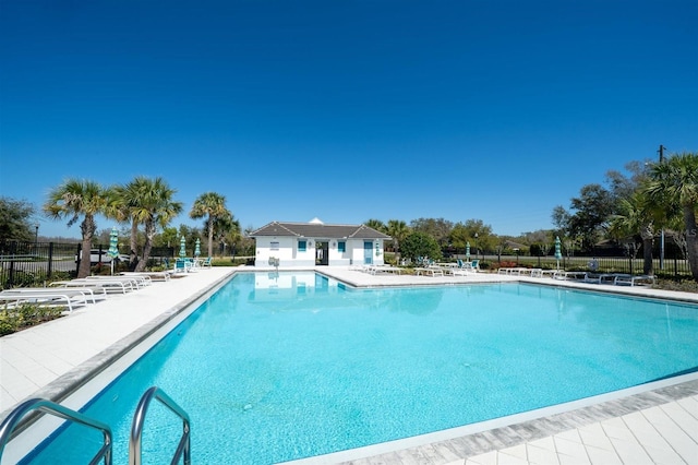 community pool featuring a patio area and fence