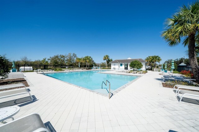 pool featuring a patio area and fence