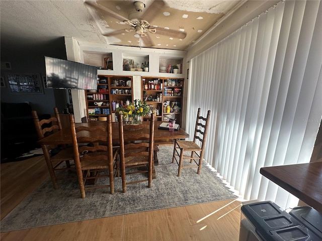 dining room featuring a ceiling fan and wood finished floors