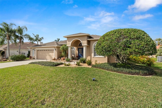 view of front of house featuring a front yard, driveway, an attached garage, and stucco siding