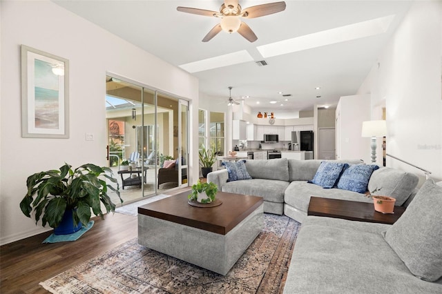 living area with ceiling fan, wood finished floors, visible vents, and recessed lighting