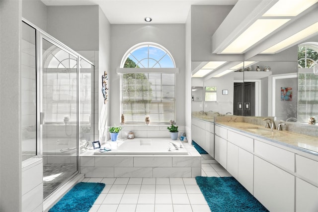 bathroom with tile patterned flooring, a garden tub, a shower stall, and vanity