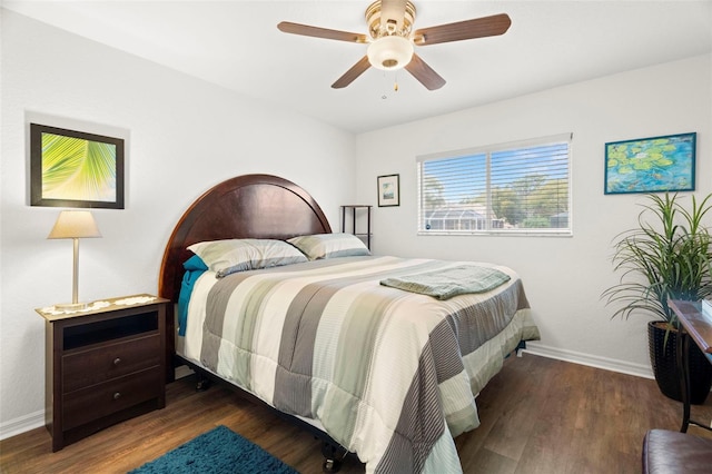 bedroom with ceiling fan, baseboards, and wood finished floors