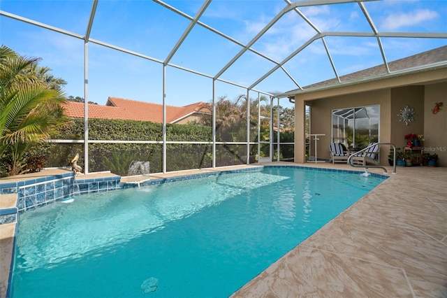 pool with glass enclosure and a patio area