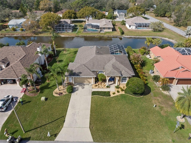 drone / aerial view with a water view and a residential view