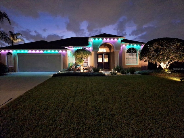 view of front of house with a garage, concrete driveway, and a front yard