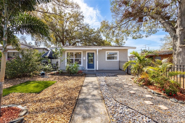 view of front of home with fence and stucco siding