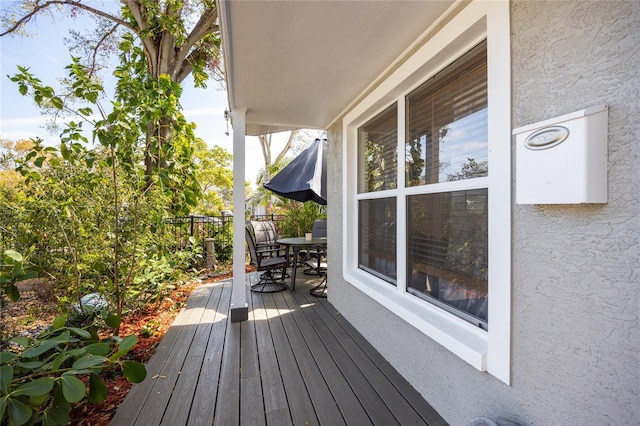 wooden terrace with outdoor dining area