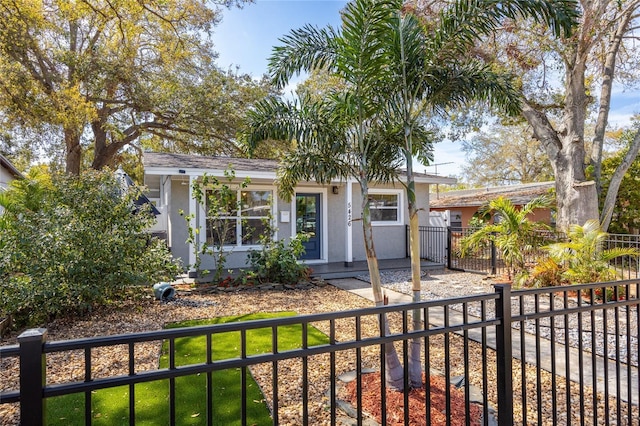 view of front facade featuring fence and stucco siding