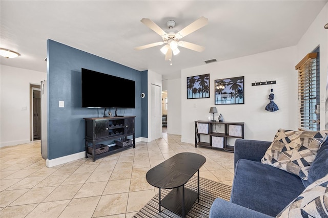 living room with light tile patterned floors, baseboards, visible vents, and a ceiling fan