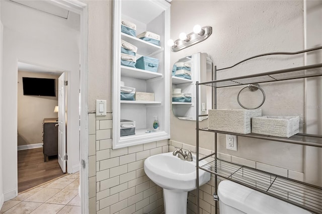 bathroom with toilet and tile patterned floors