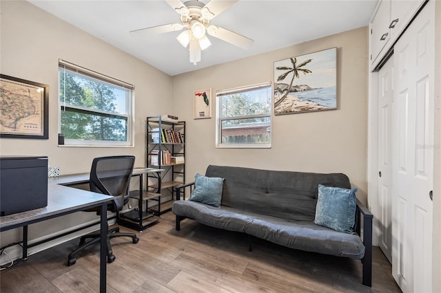 office area with light wood-style flooring and ceiling fan