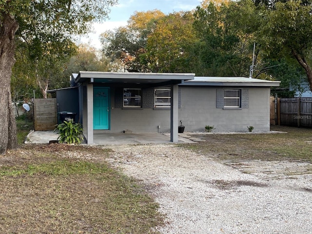 exterior space with concrete block siding and fence