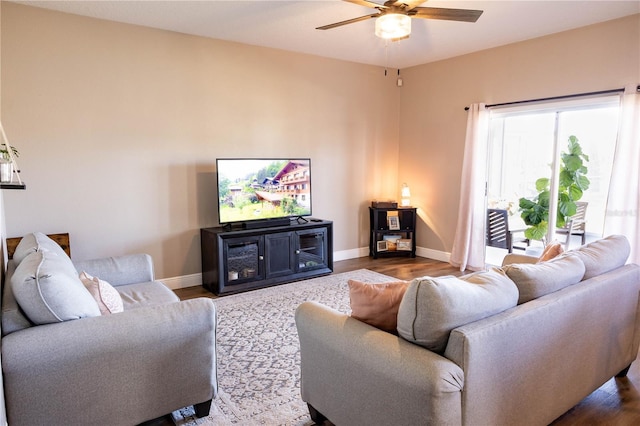 living room with ceiling fan, wood finished floors, and baseboards