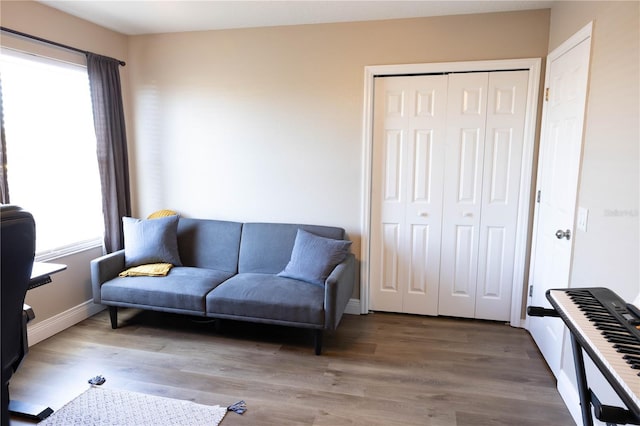 living area featuring baseboards and wood finished floors