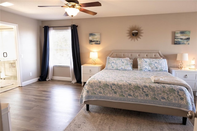 bedroom with ceiling fan, connected bathroom, baseboards, and wood finished floors