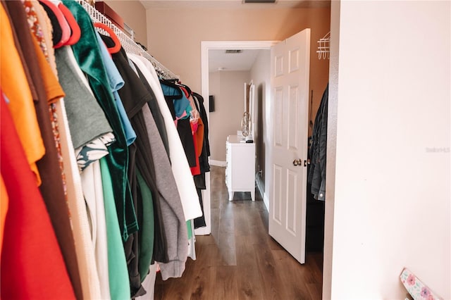 spacious closet featuring wood finished floors and visible vents