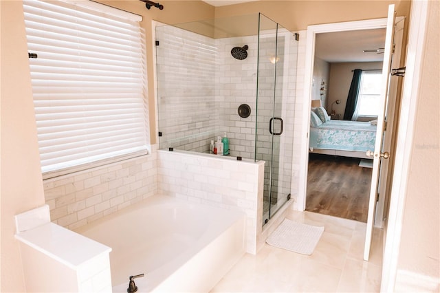 ensuite bathroom featuring a garden tub, a shower stall, tile patterned floors, and ensuite bathroom