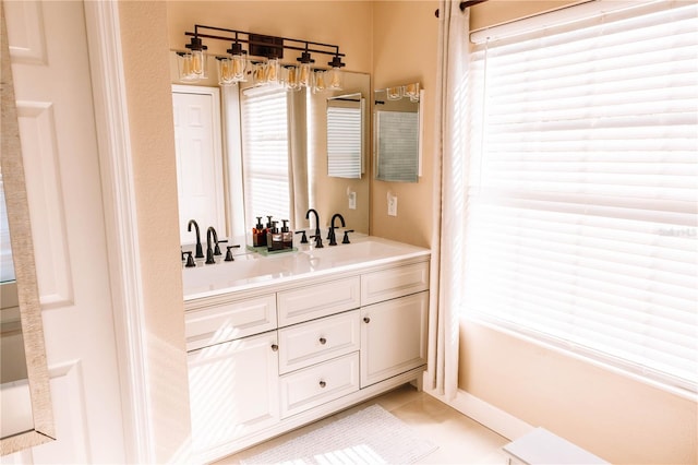 bathroom featuring double vanity, tile patterned flooring, and a sink