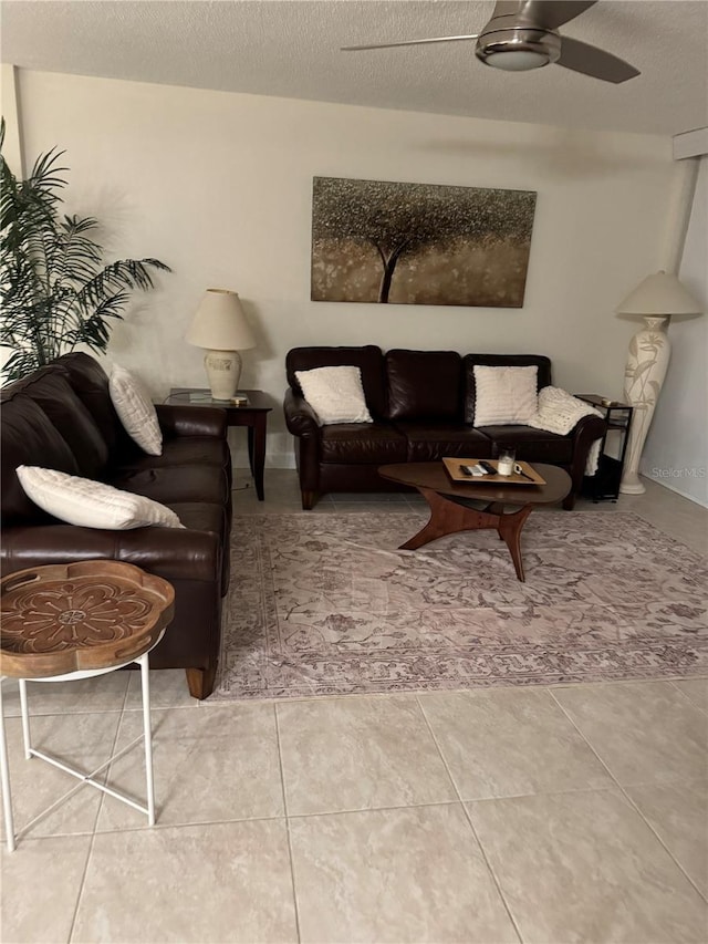 living area featuring a textured ceiling and a ceiling fan