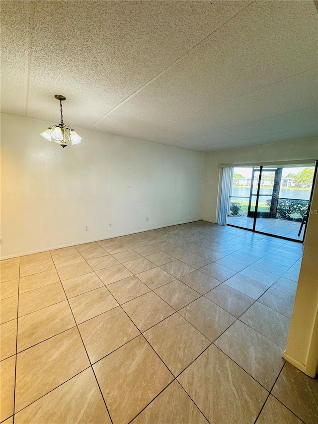 tiled spare room with a textured ceiling