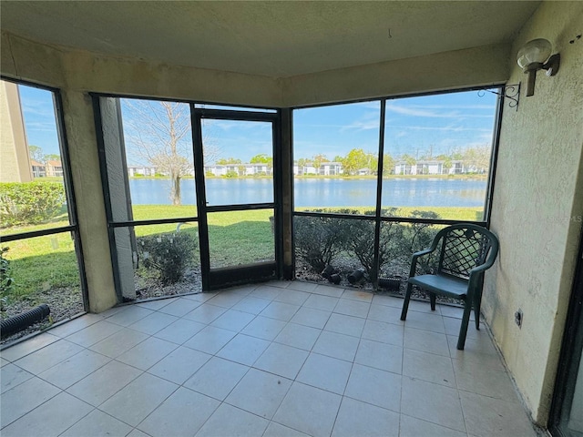 unfurnished sunroom with a water view