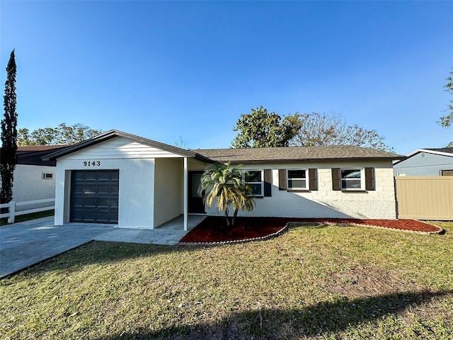 ranch-style home featuring an attached garage, fence, and a front lawn