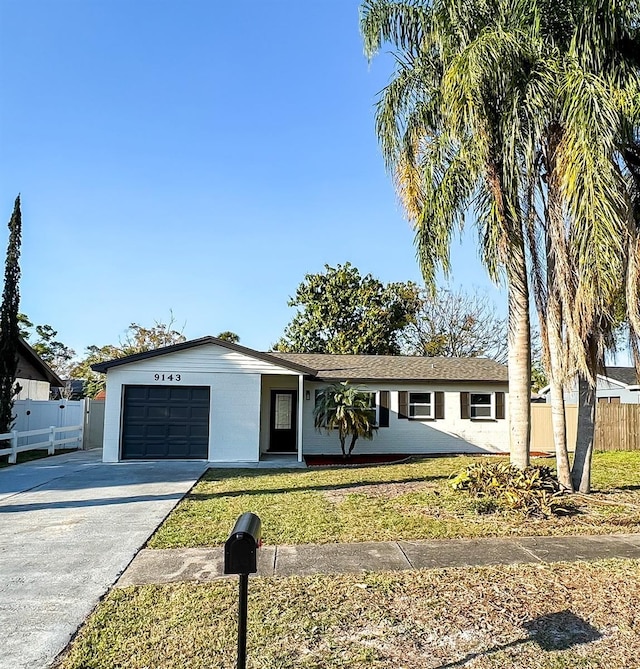 single story home featuring stucco siding, an attached garage, fence, driveway, and a front lawn