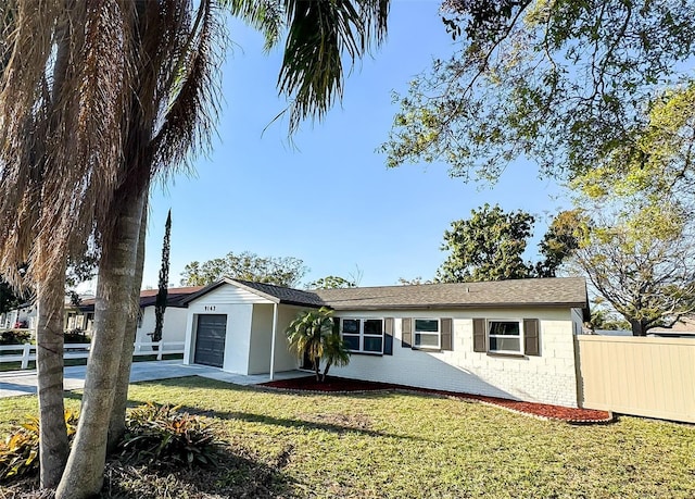 single story home featuring an attached garage, brick siding, a front yard, and fence