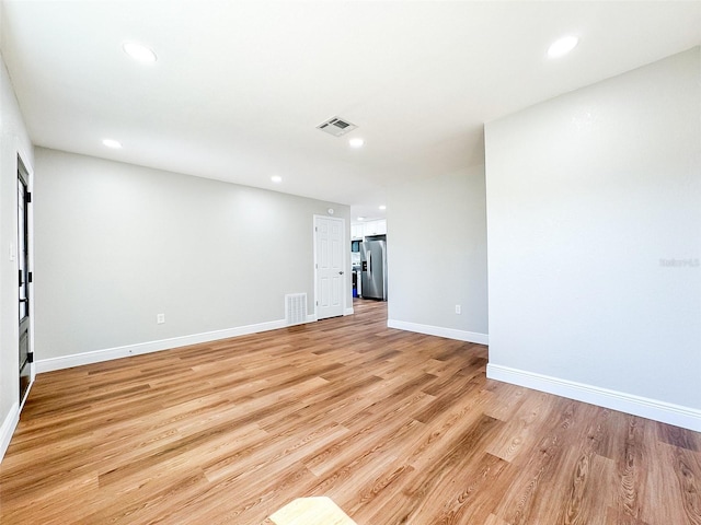 unfurnished room with baseboards, recessed lighting, visible vents, and light wood-style floors