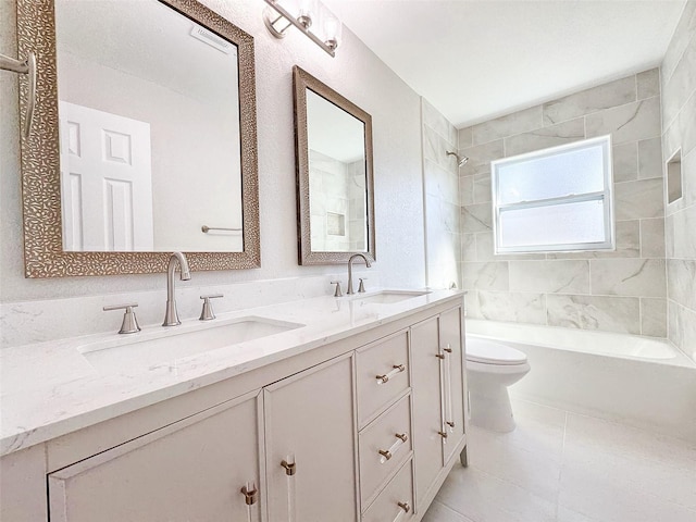 full bath featuring toilet, double vanity, a sink, and washtub / shower combination