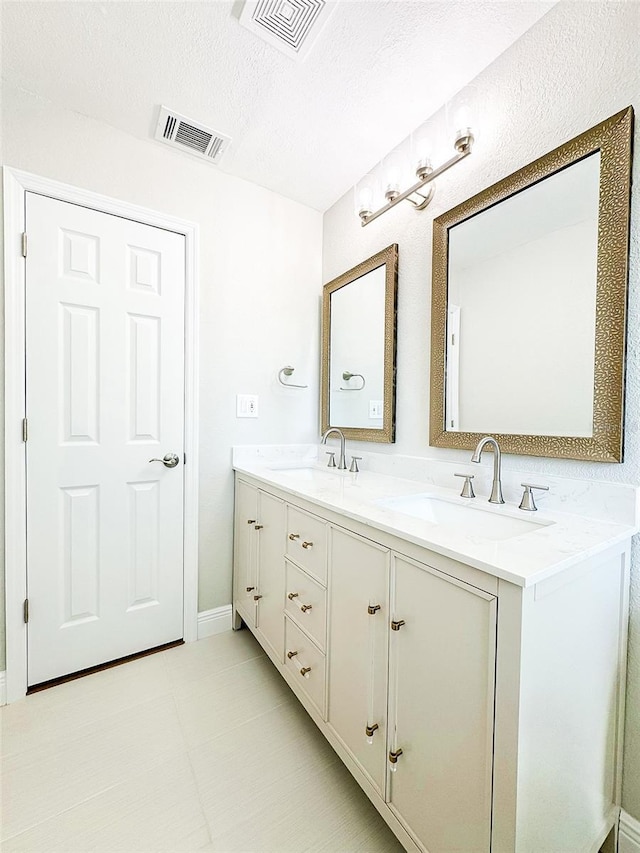 full bathroom featuring visible vents, a sink, and double vanity