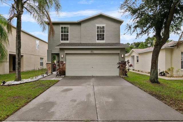 traditional home featuring driveway, a front yard, a garage, and stucco siding