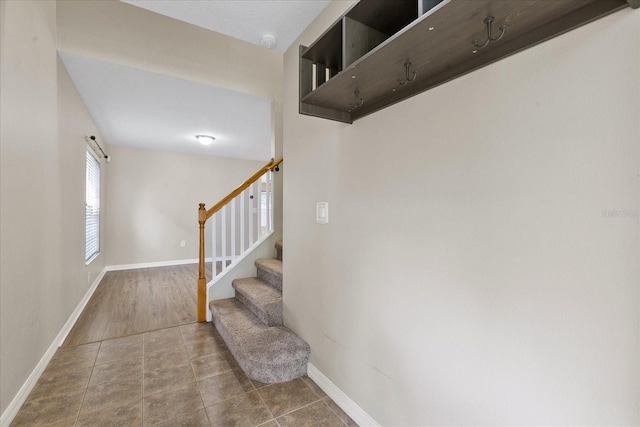 staircase featuring tile patterned flooring and baseboards