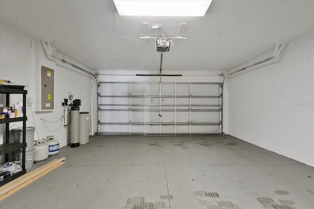 garage with electric panel and a garage door opener