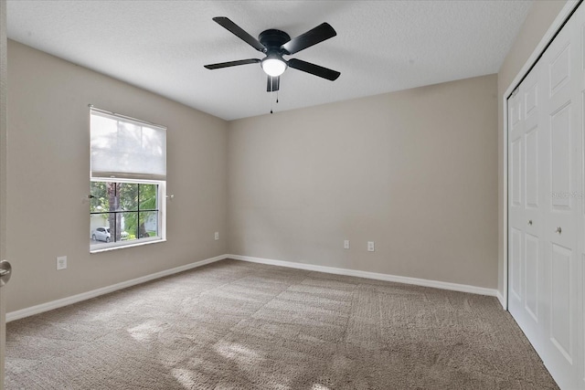 unfurnished bedroom featuring carpet floors, a closet, and a textured ceiling