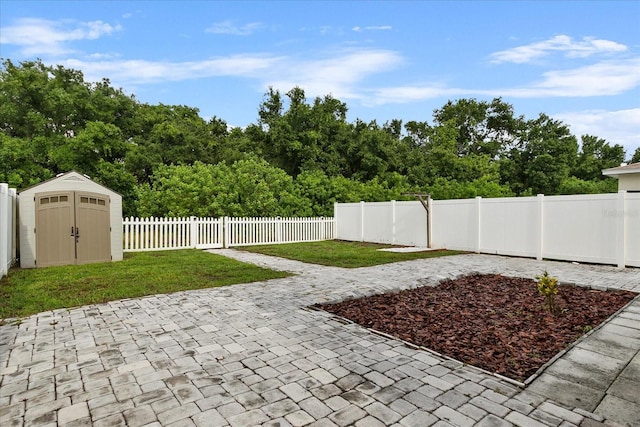 view of patio / terrace with a shed, a fenced backyard, and an outdoor structure