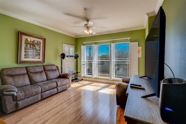 living area featuring ornamental molding, a ceiling fan, and wood finished floors