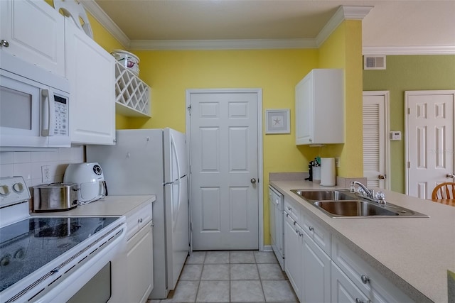 kitchen featuring visible vents, ornamental molding, white cabinets, a sink, and white appliances