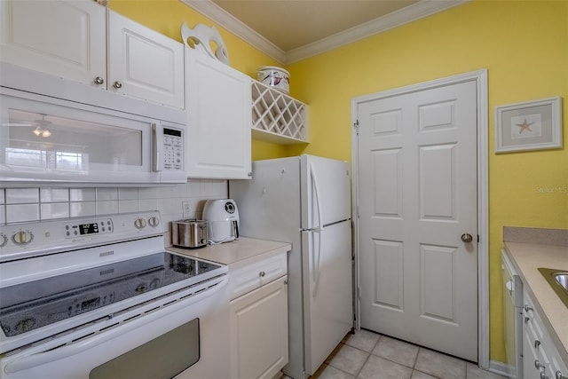 kitchen featuring crown molding, light tile patterned floors, backsplash, white cabinetry, and white appliances