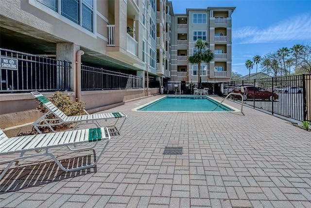 pool featuring a patio area and fence