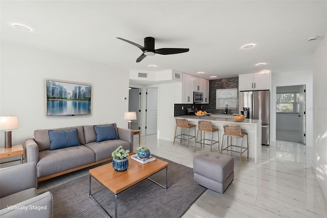 living room with recessed lighting, marble finish floor, visible vents, and ceiling fan