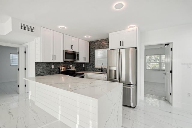 kitchen featuring marble finish floor, visible vents, appliances with stainless steel finishes, and a sink