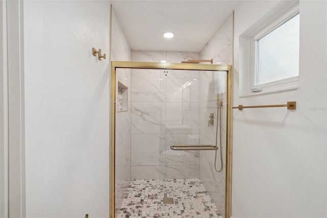 full bath featuring a marble finish shower