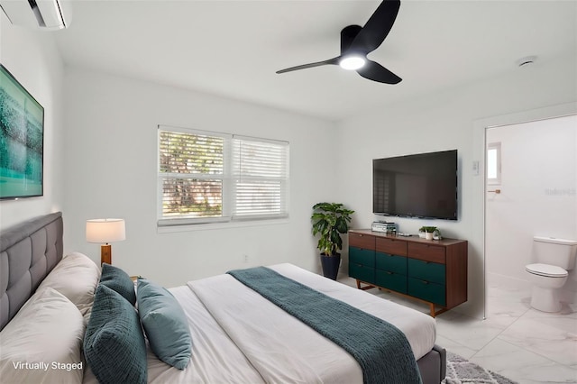 bedroom featuring marble finish floor, ceiling fan, ensuite bathroom, and a wall mounted AC