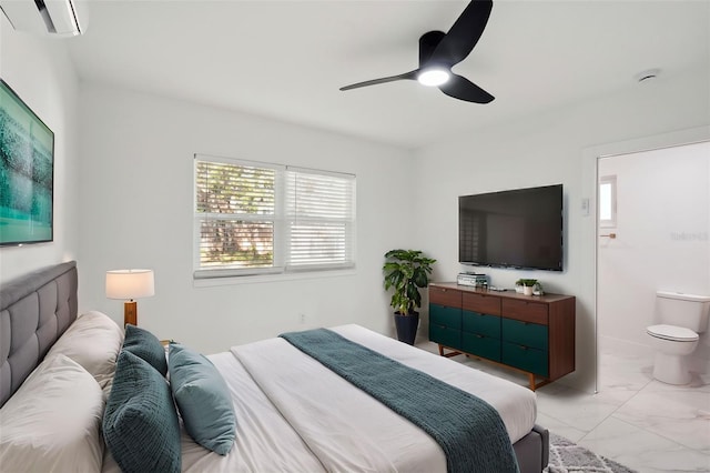 bedroom with ceiling fan, marble finish floor, a wall mounted air conditioner, and connected bathroom