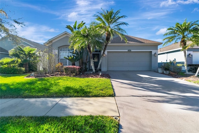 view of front of home with a front yard, driveway, an attached garage, and stucco siding