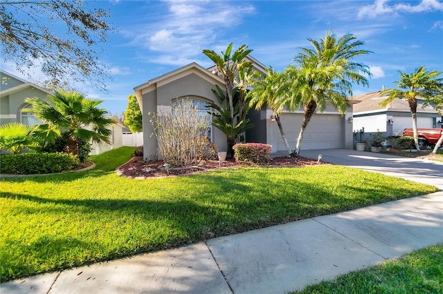 view of front of property with a garage, driveway, a front lawn, and stucco siding