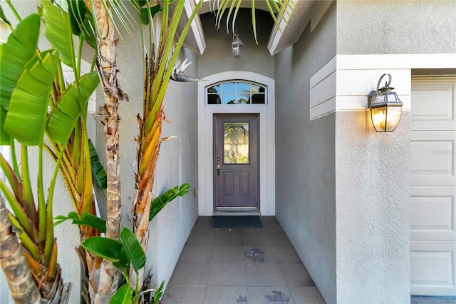 property entrance with stucco siding