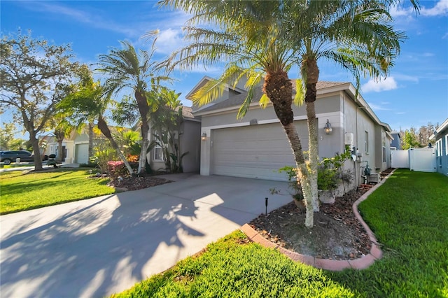 view of front of home with an attached garage, a front yard, concrete driveway, and stucco siding